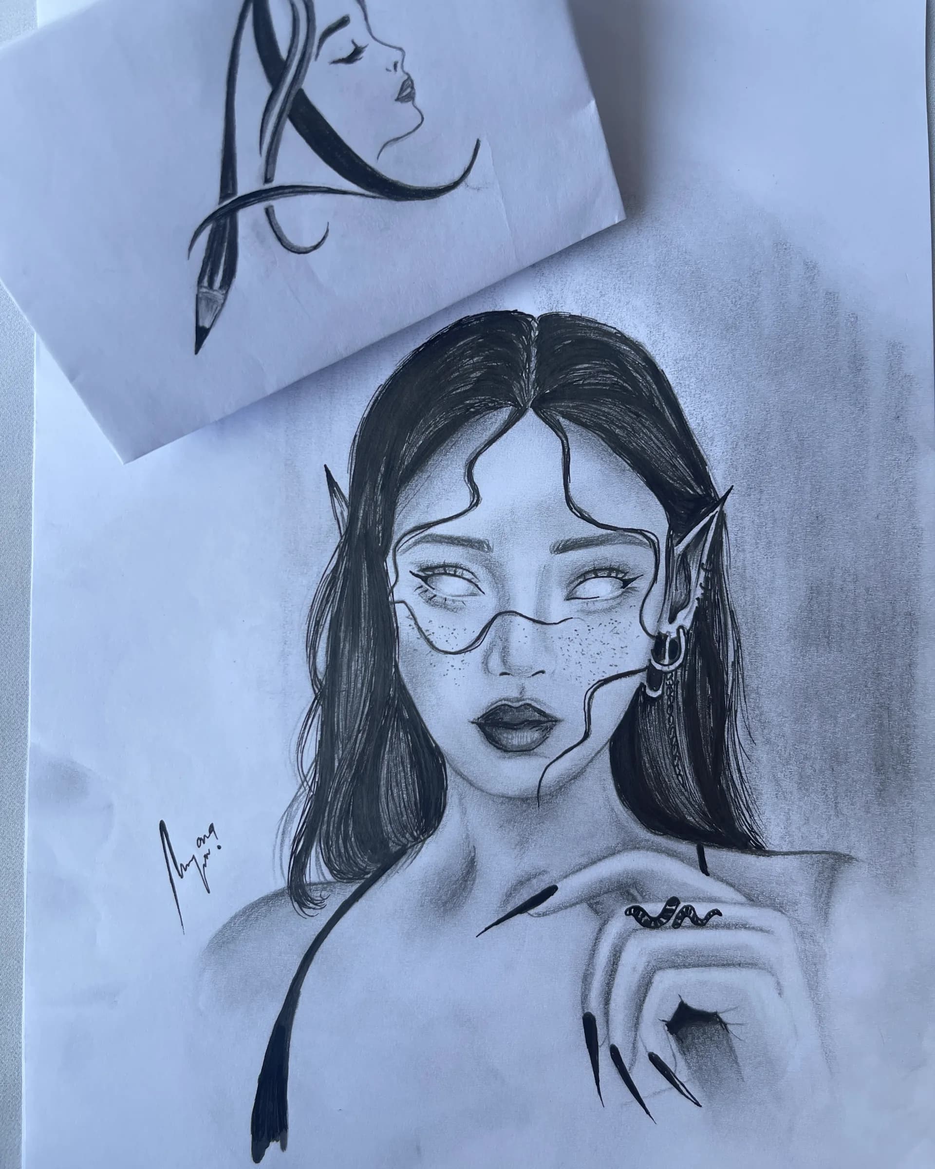 Hand-drawn graphite fantasy portrait of a female character with pointed ears, blank eyes, freckles, long dark hair, and detailed jewelry by Ammama Sketch.