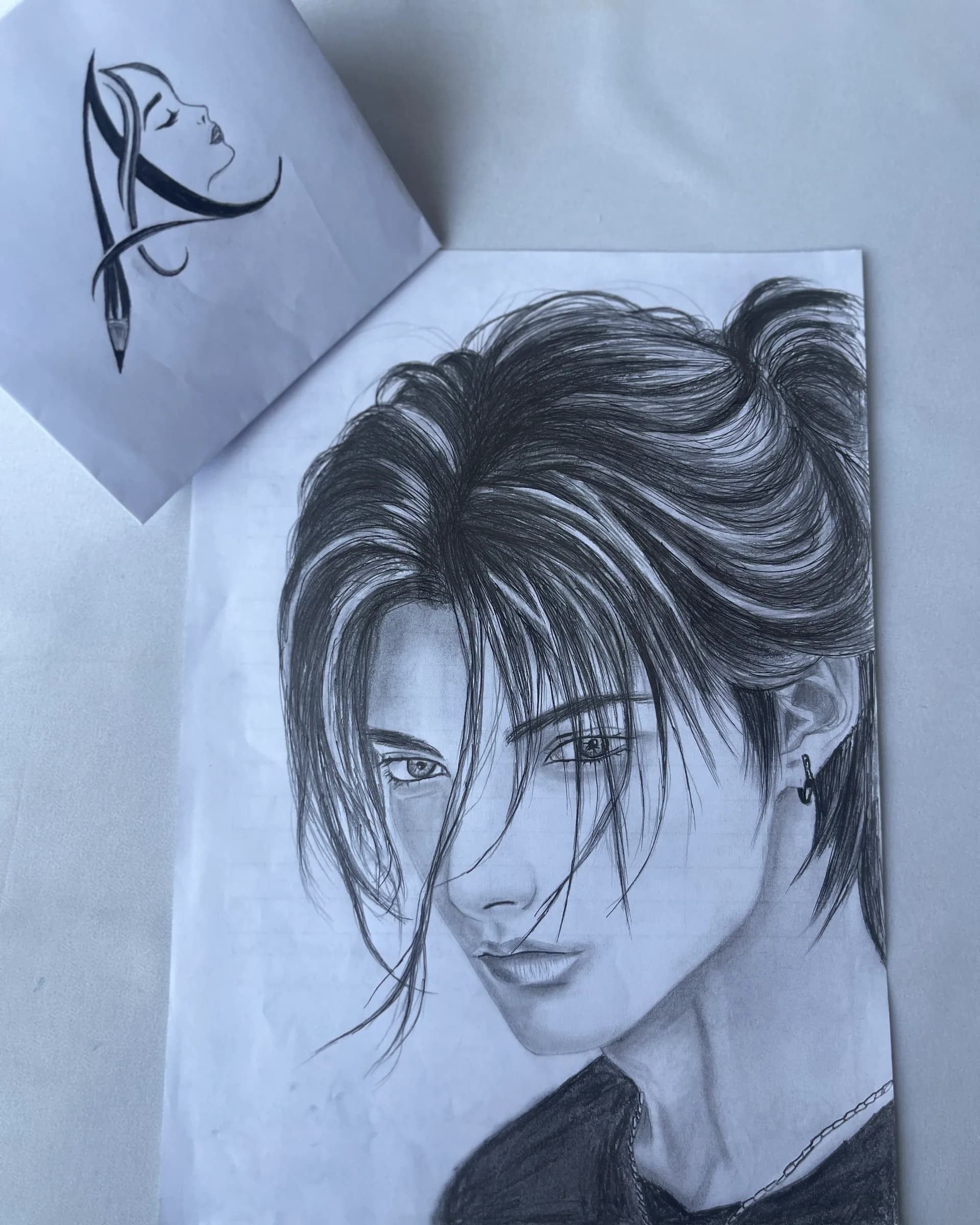 Hand-drawn pencil character portrait featuring detailed eyes, layered hair, soft facial shading, and expressive line work by Ammama Sketch.