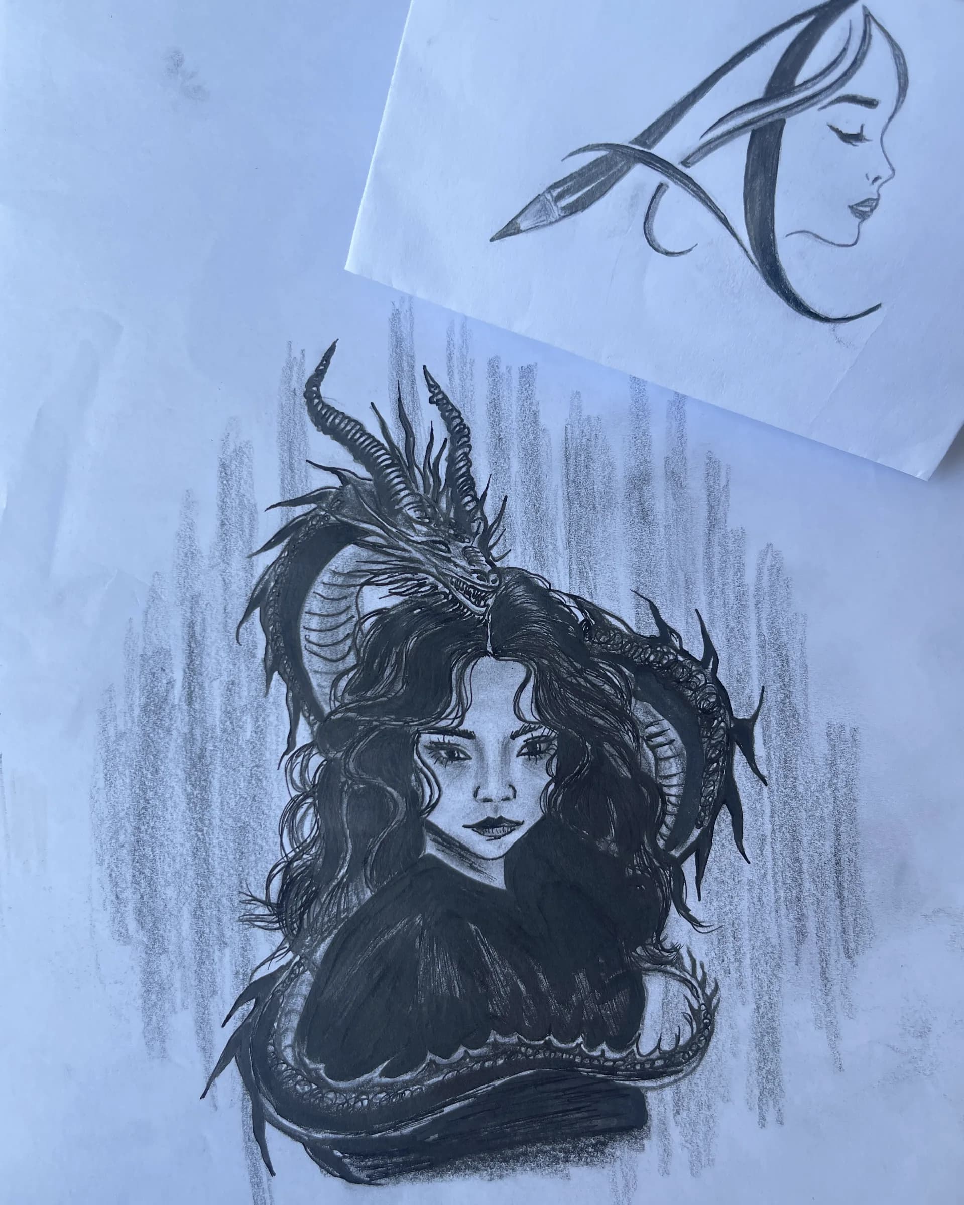 Hand-drawn graphite fantasy character artwork featuring a woman surrounded by horned, dragon-like forms with dramatic shading and dark pencil details by Ammama Sketch.